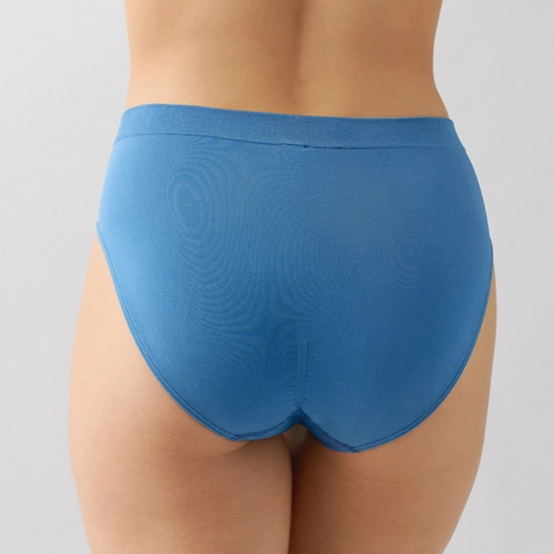 Blue underwear worn by a person on a gray background