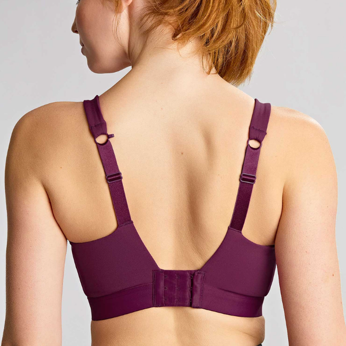 Purple bra worn by a person on a plain background