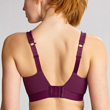 Purple bra worn by a person on a plain background