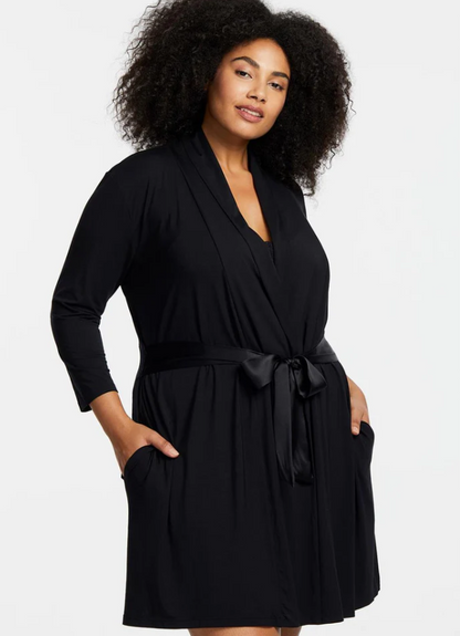 Woman wearing a black robe against a white background