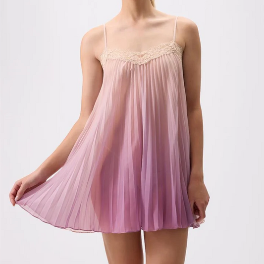 Woman wearing a pink gradient nightgown against a white background