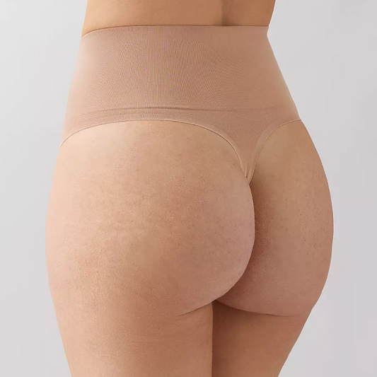 Beige shapewear worn by a person on a light gray background