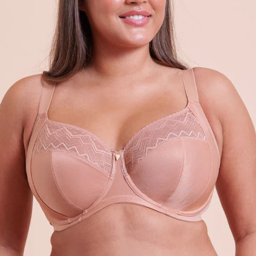 Woman wearing a beige bra against a white background